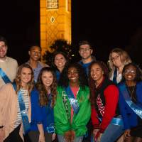 Homecoming court group photo in front of the GVSU clocktower